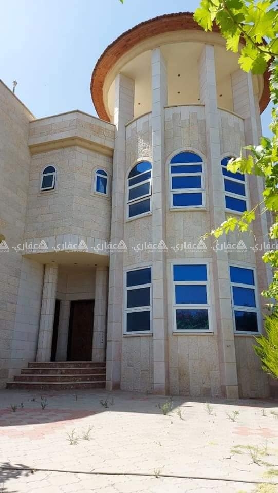 فيلا حجر قدسي، ملفوفة بحديقة خضراء وردية
